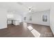 Bright living room with wood floors, ceiling fan, and an open floor plan with lots of natural light at 3418 Saddlebred Dr, Gastonia, NC 28052
