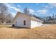 Exterior of the home with vinyl siding, small windows, and a small back yard at 407 S Spargo St, Dallas, NC 28034