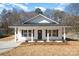 Charming home showcasing its inviting front porch, new landscaping, and well-manicured lawn at 407 S Spargo St, Dallas, NC 28034