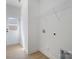 Laundry room with washer and dryer hookups, overhead wire shelving, and rear exit door at 407 S Spargo St, Dallas, NC 28034