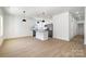 Open-concept floor plan with luxury vinyl flooring, abundant light, eat-in kitchen, and modern pendants at 407 S Spargo St, Dallas, NC 28034