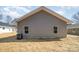 A view of the rear exterior showing the home's gray siding and windows at 409 S Spargo St, Dallas, NC 28034