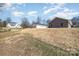 Backyard view showcases the home's setting and surrounding landscaping at 409 S Spargo St, Dallas, NC 28034
