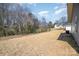 Expansive backyard with bare soil and distant trees at 409 S Spargo St, Dallas, NC 28034