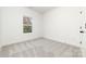 A well-lit bedroom features neutral carpet and paint and a window providing natural light at 409 S Spargo St, Dallas, NC 28034