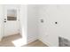 Mud room with white walls and trim featuring wood-look floors, a white metal shelf and a back door at 409 S Spargo St, Dallas, NC 28034