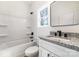 A bright bathroom with a tub, shower and vanity with granite countertop at 411 S Spargo St, Dallas, NC 28034