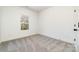 A minimalist bedroom featuring neutral carpet, a window, and an electrical outlet at 411 S Spargo St, Dallas, NC 28034