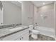 Well-lit bathroom with granite vanity, tiled shower, and modern fixtures at 427 Queens Ct, Gastonia, NC 28052