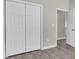 The bedroom features gray wood-look flooring and closet space, adding both style and convenience at 427 Queens Ct, Gastonia, NC 28052