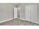 Bedroom showing the gray wood-look flooring, closet and bathroom access at 427 Queens Ct, Gastonia, NC 28052