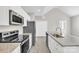 Open kitchen with stainless appliances, granite counters, and ample cabinet space at 427 Queens Ct, Gastonia, NC 28052