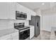 Well-equipped kitchen features stainless steel appliances and sleek white cabinetry at 427 Queens Ct, Gastonia, NC 28052