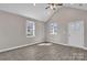 A bright room with luxury vinyl plank flooring, two windows, and a white front door at 427 Queens Ct, Gastonia, NC 28052