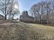Backyard view of the home's elevation, a shed and tree line at 4516 Jamee Dr, Gastonia, NC 28056