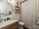 Bathroom with updated vanity, marble countertop, round mirror, and shower with curtain at 4516 Jamee Dr, Gastonia, NC 28056