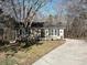 Inviting home with a long driveway, tidy landscaping, and classic shutters, nestled among mature trees at 4516 Jamee Dr, Gastonia, NC 28056