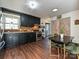 Stylish kitchen features stainless steel appliances, dark cabinetry, and hardwood flooring at 4516 Jamee Dr, Gastonia, NC 28056