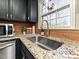 Kitchen sink with granite countertop, black cabinets, a gold faucet, and a window view at 4516 Jamee Dr, Gastonia, NC 28056