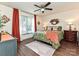 Sunlit main bedroom with wood floors, ceiling fan, and decorative furnishings at 4516 Jamee Dr, Gastonia, NC 28056