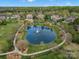 Aerial view of the community pond with a fountain, surrounded by lush landscaping and well-maintained homes at 5005 Autumn Blossom Ln, Waxhaw, NC 28173