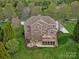 Aerial view of the home with a large yard, patio, outdoor kitchen, and mature trees at 5005 Autumn Blossom Ln, Waxhaw, NC 28173