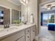 This bathroom has double sinks, white cabinets, and neutral walls at 5005 Autumn Blossom Ln, Waxhaw, NC 28173