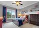 Comfortable bedroom with a colorful quilt, blue curtains, and dark wood furniture at 5005 Autumn Blossom Ln, Waxhaw, NC 28173