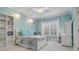 Bright bedroom with turquoise walls, white furniture, large window and stylish lighting fixtures at 5005 Autumn Blossom Ln, Waxhaw, NC 28173