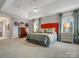 Large, bright bedroom with orange headboard, neutral decor, tray ceiling, and two large windows at 5005 Autumn Blossom Ln, Waxhaw, NC 28173