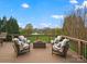 Serene outdoor deck area with comfortable seating and views of a beautiful landscaped yard and water feature at 5005 Autumn Blossom Ln, Waxhaw, NC 28173
