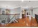 Upstairs landing showcasing the hardwood floors and stairs with iron banister at 5005 Autumn Blossom Ln, Waxhaw, NC 28173