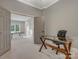 Bright home office with neutral paint, glass top desk, and an additional room beyond a wide doorframe at 5005 Autumn Blossom Ln, Waxhaw, NC 28173