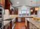 Bright kitchen with cherry cabinets, white subway tile backsplash, stainless steel appliances, and granite countertops at 5005 Autumn Blossom Ln, Waxhaw, NC 28173