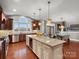 Spacious kitchen featuring cherry cabinets, stainless steel appliances, granite countertops, and a large center island at 5005 Autumn Blossom Ln, Waxhaw, NC 28173