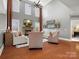 Bright and airy living room with soaring ceilings, stone fireplace, hardwood floors, and neutral furnishings at 5005 Autumn Blossom Ln, Waxhaw, NC 28173