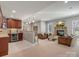Well-lit living room featuring a stone fireplace, wet bar, brown furniture, and ample space for entertaining at 5005 Autumn Blossom Ln, Waxhaw, NC 28173