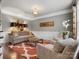 Elegant living room with crown molding, wainscoting, designer rug, and sophisticated decor at 5005 Autumn Blossom Ln, Waxhaw, NC 28173
