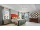 Bright main bedroom with tray ceiling, neutral tones and large windows allowing natural light into the luxurious space at 5005 Autumn Blossom Ln, Waxhaw, NC 28173