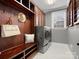 Well-organized mudroom with built-in storage, bench seating, and modern washer and dryer at 5005 Autumn Blossom Ln, Waxhaw, NC 28173