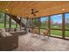 Inviting screened porch with stone flooring, wood ceiling, comfortable seating, and views of the landscaped backyard at 5005 Autumn Blossom Ln, Waxhaw, NC 28173