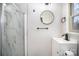 Renovated bathroom with glass shower, black fixtures, and round mirror at 5310 Myrica Ln, Charlotte, NC 28213
