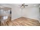 Open dining room featuring wood floors, a ceiling fan, and access to the kitchen and other rooms at 5310 Myrica Ln, Charlotte, NC 28213