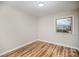 Empty room featuring wood floors and a bright window that provide lots of natural light at 5310 Myrica Ln, Charlotte, NC 28213
