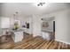 Open floor plan showcasing a kitchen island, white cabinets, and stainless steel appliances at 5310 Myrica Ln, Charlotte, NC 28213