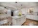 Open kitchen features a granite island, white cabinets, and stainless steel appliances at 5310 Myrica Ln, Charlotte, NC 28213