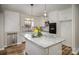 Bright kitchen with granite island, white cabinets, and stainless steel dishwasher and oven at 5310 Myrica Ln, Charlotte, NC 28213