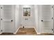 Functional laundry room with two closets, hardwood floors, a window, and a hookup at 5310 Myrica Ln, Charlotte, NC 28213