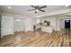Spacious living room features wood floors, access to kitchen, and a ceiling fan at 5310 Myrica Ln, Charlotte, NC 28213