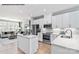 Bright white kitchen featuring an island, stainless steel appliances, and an open floor plan at 6006 Fonsac Ln # 2006D, Charlotte, NC 28217